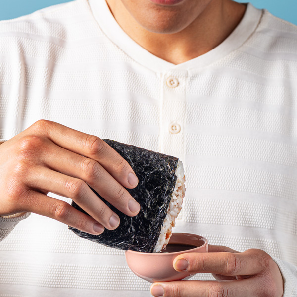 Sushi Pockets being dipped in sauce
